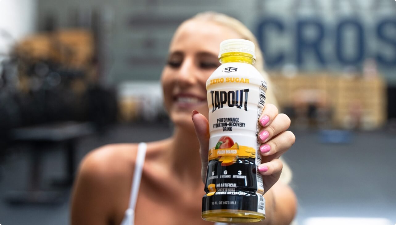 Woman holding TapouT bottle